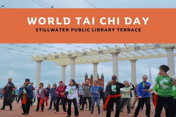 People outside on library terrace doing tai chi