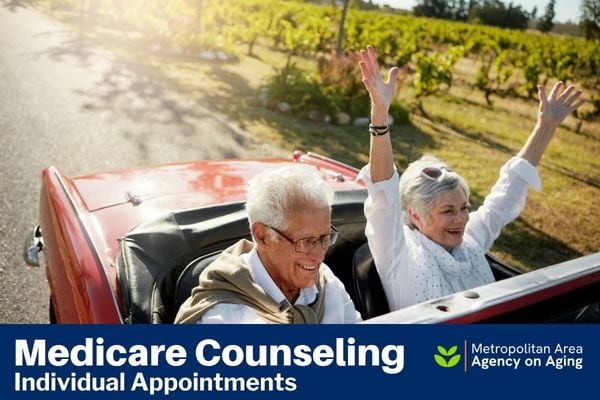 Two senior adults in convertible car on a country road